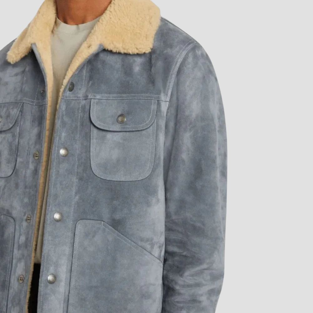 Stay warm and stylish this season with this men’s blue suede trucker jacket, complete with a cozy curly fur lining.