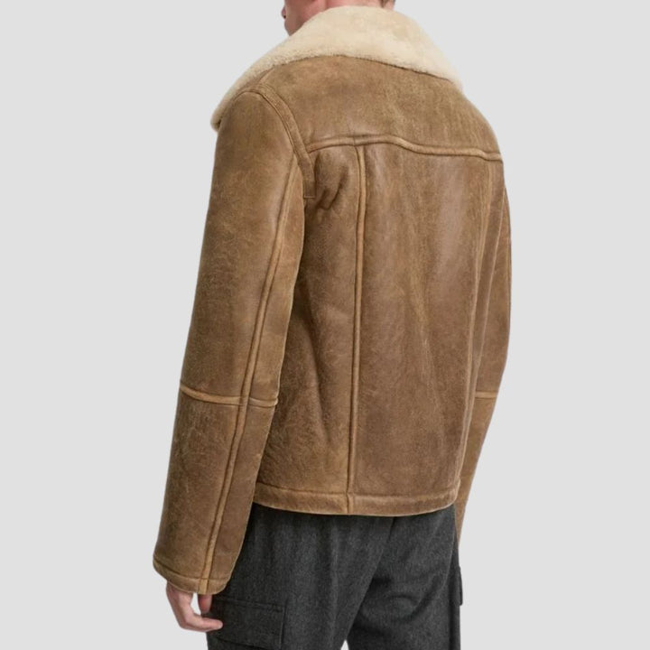 Embrace the cold season in style with this men’s brown fur leather jacket, crafted to keep you cozy and fashionable.