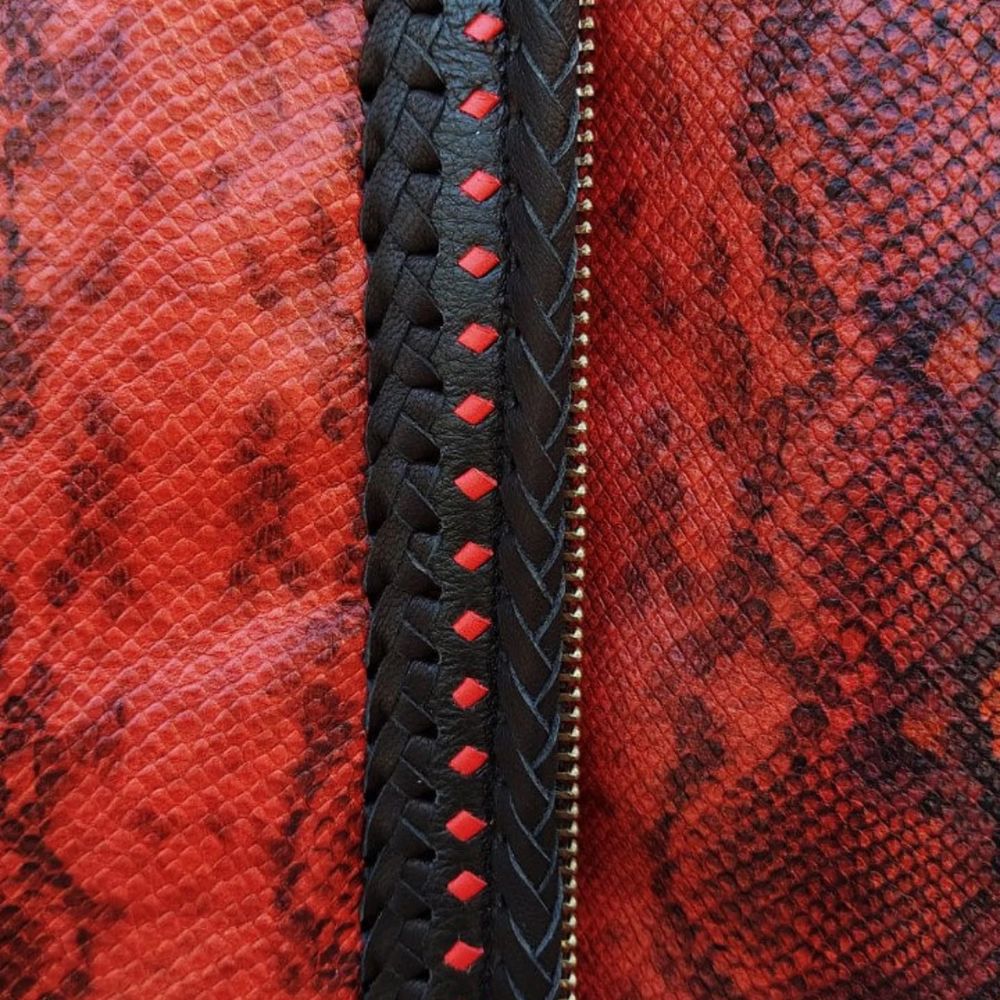Men’s vibrant red leather vest with snake-skin pattern, perfect for motorcycle riders.