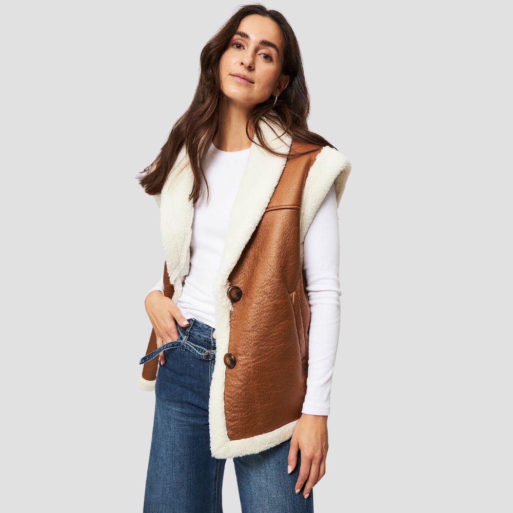 Women’s shearling leather vest featuring chic fur accents, blending elegance and warmth for a fashionable winter wardrobe.