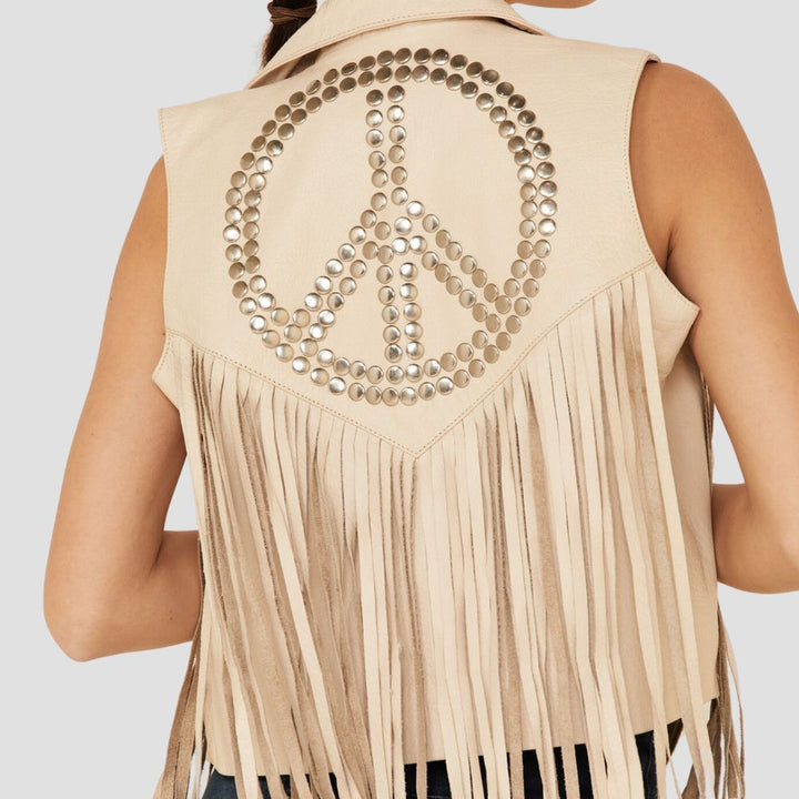  Trendy long fringes leather vest for women with studded details, perfect for achieving a chic cowgirl-inspired fashion look.