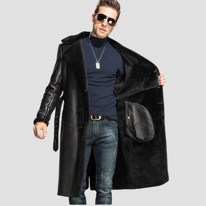 Front view of a men’s black leather shearling coat with a buttoned closure and soft fur interior.
