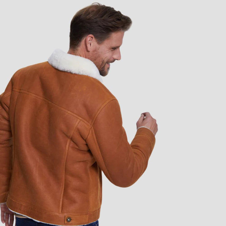 Classic sheepskin leather trucker jacket with white faux fur for warmth.